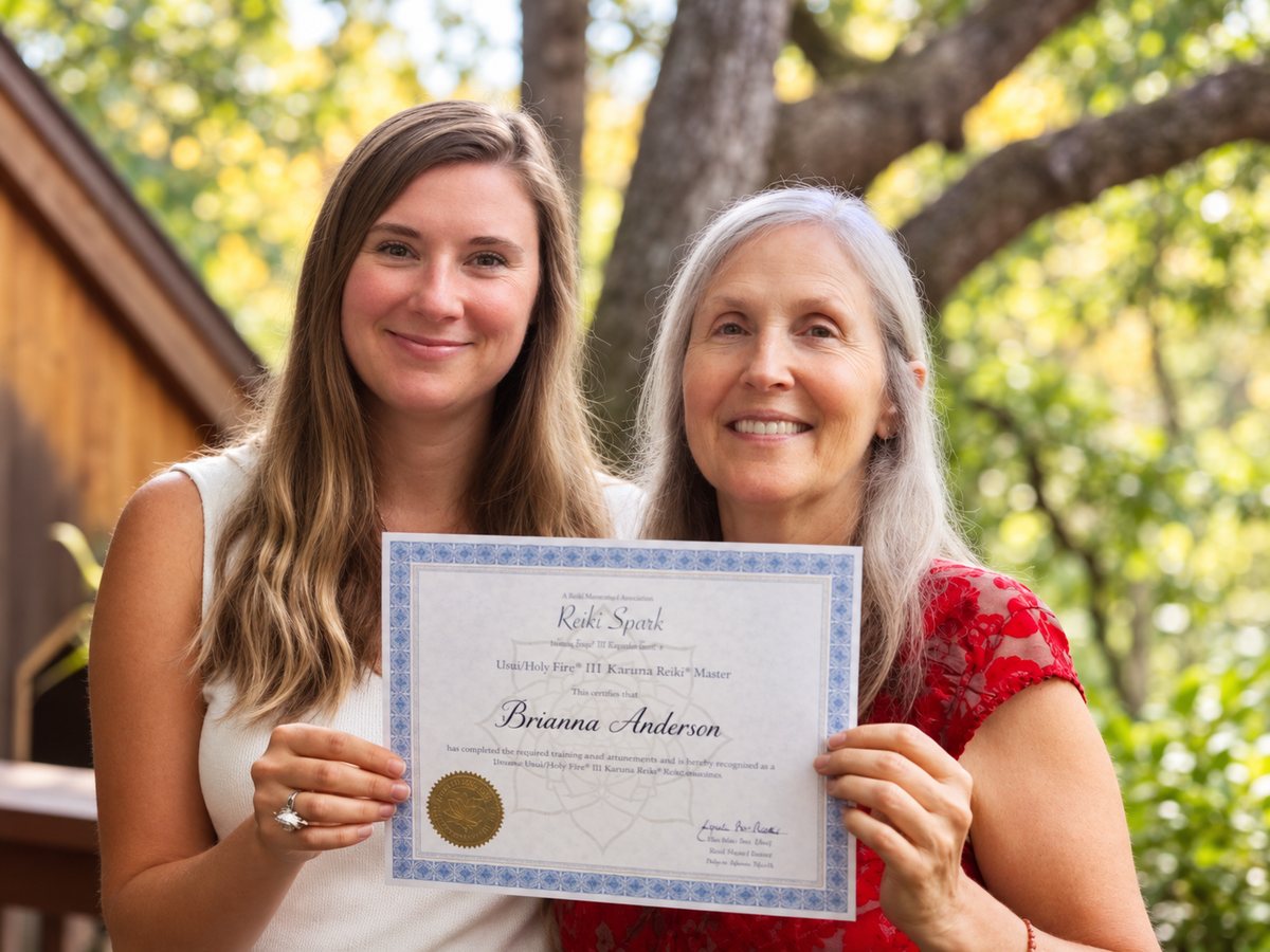 Brianna Anderson with Lynetta, holding her Karuna Reiki Master certificate