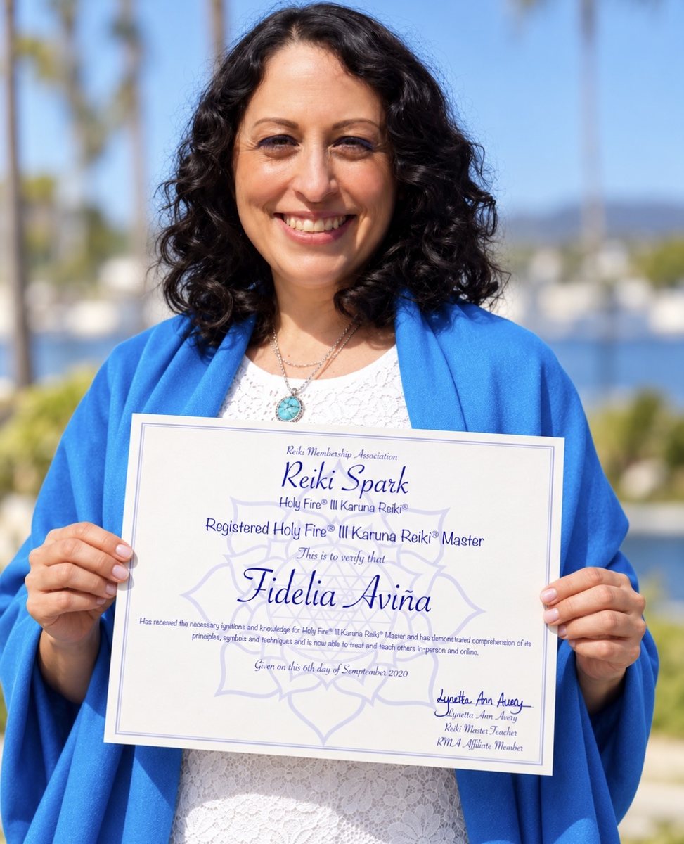 Fidelia Aviña holding her Holy Fire III Karuna Reiki Master certificate