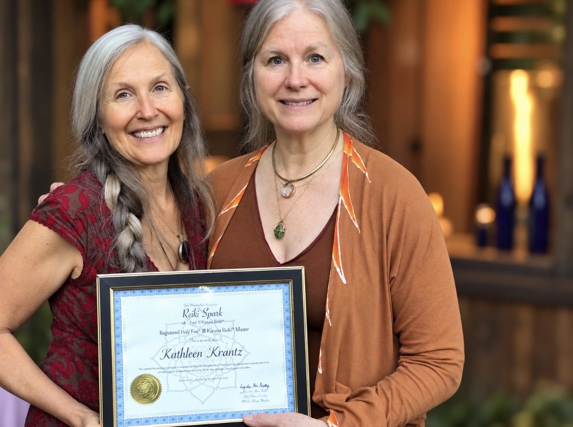 Kathleen Krantz with Lynetta, holding her framed Karuna Reiki Master certificate