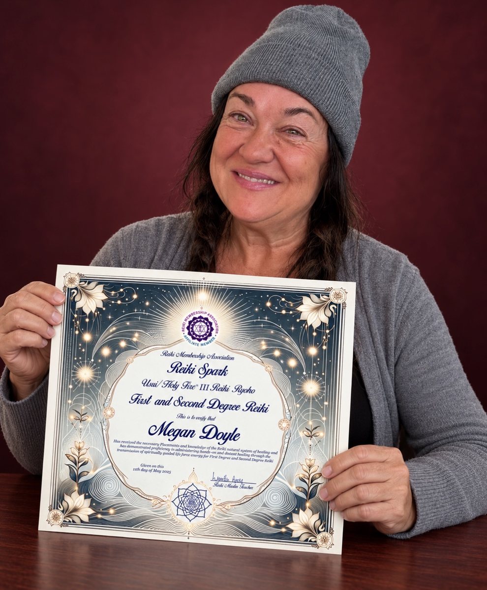 Megan Doyle holding her First and Second Degree Reiki certificate