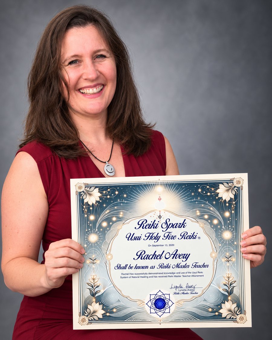 Rachel Avery holding her Reiki Master Teacher certificate